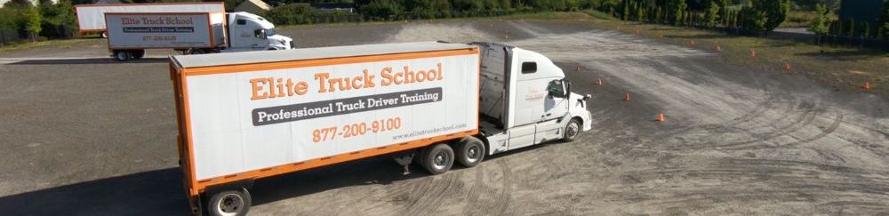Image of two Elite Truck School semi trucks driving on the range at the Elite Truck School Hillsboro Campus, from an aerial view.