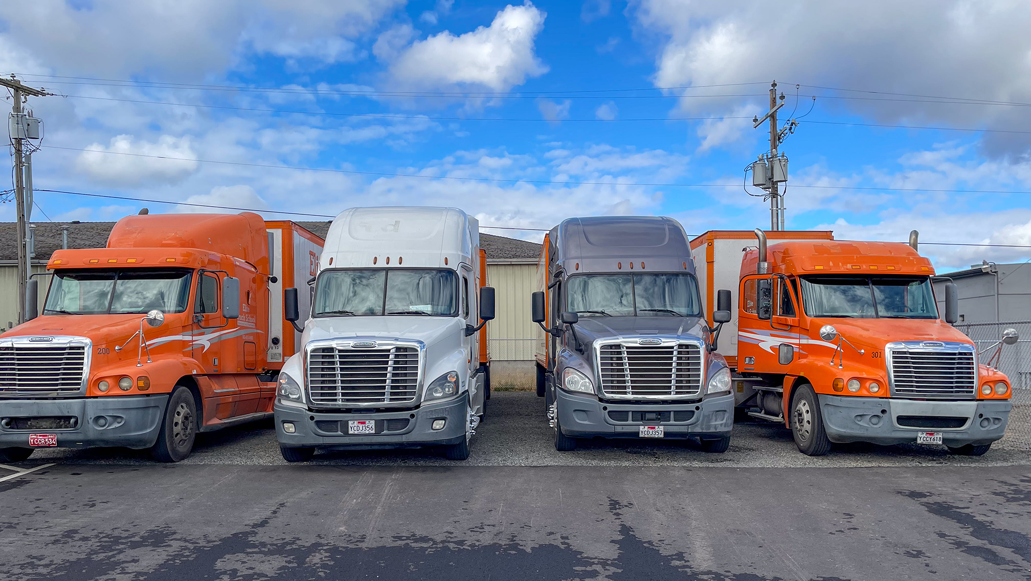 Four different Elite semi trucks parked in a row