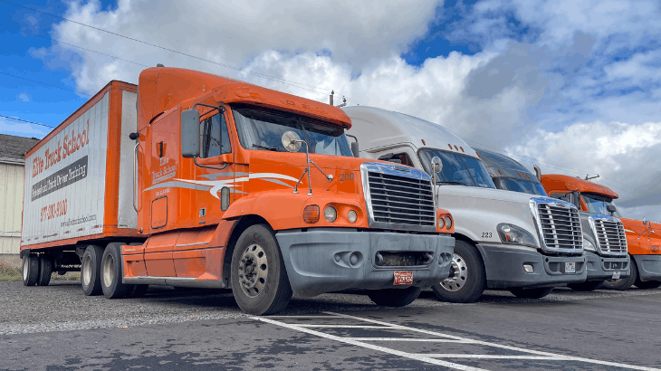 Three Elite semi trucks parked in a line
