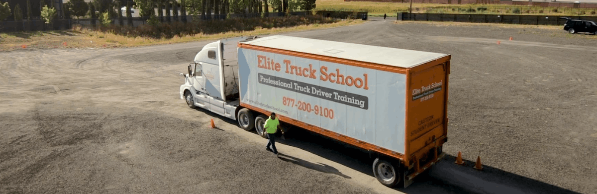 Drone view of Elite semi truck and instructor in training yard