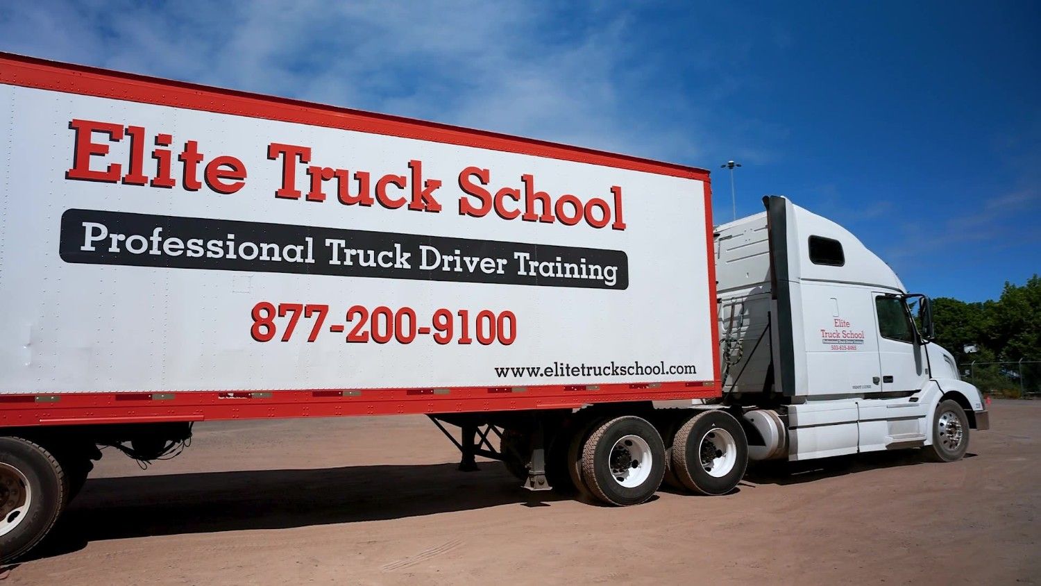 Side view of Elite Truck School semi truck in dirt training yard