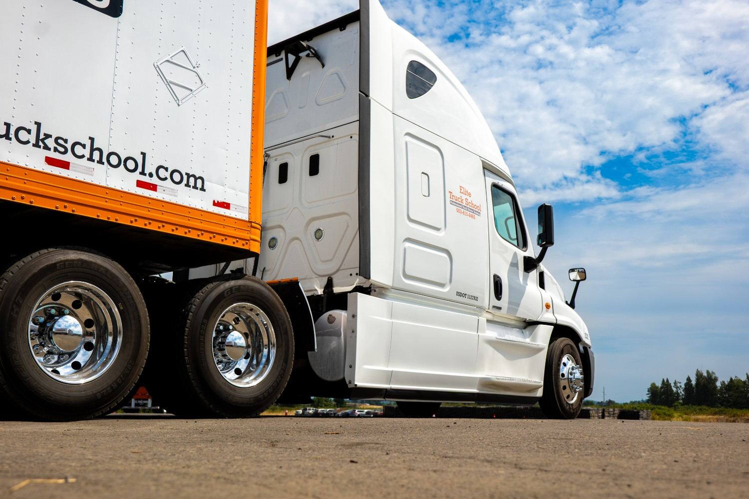 Back view of an Elite semi truck under a blue sky